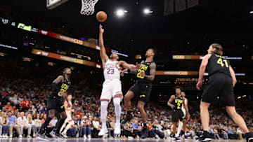 PHOENIX, ARIZONA - OCTOBER 28: Eric Gordon #23 of the Phoenix Suns puts up a shot ahead of John Collins #20 of the Utah Jazz during the NBA game against the Utah Jazz at Footprint Center on October 28, 2023 in Phoenix, Arizona. The Suns defeated the Jazz 126-104. NOTE TO USER: User expressly acknowledges and agrees that, by downloading and or using this photograph, User is consenting to the terms and conditions of the Getty Images License Agreement. (Photo by Christian Petersen/Getty ImagJohn Collins #20 of the Utah Jazz