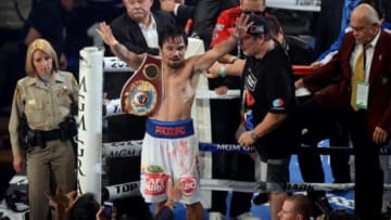 Apr 12, 2014; Las Vegas, NV, USA; Manny Pacquiao celebrates after defeating Tomothy Bradley Jr. (not pictured in their WBO World Welterweight Title bout at MGM Grand Garden Arena. Pacquiao won via unanimous decision. Mandatory Credit: Joe Camporeale-USA TODAY Sports