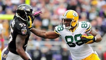 Oct 13, 2013; Baltimore, MD, USA; Green Bay Packers tight end Jermichael Finley (88) stiff arms Baltimore Ravens linebacker Terrell Suggs (55) at M