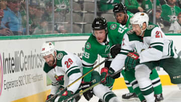 DALLAS, TX - OCTOBER 19: Greg Pateryn #29 and Eric Fehr #21 of the Minnesota Wild try to keep the puck away against Brett Ritchie #25 of the Dallas Stars at the American Airlines Center on October 19, 2018 in Dallas, Texas. (Photo by Glenn James/NHLI via Getty Images)
