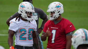 MIAMI, FLORIDA - JUNE 15: Quarterback Tua Tagovailoa #1 of the Miami Dolphins interacts with Running Back Jordan Scarlett #28 during Mandatory Minicamp at Baptist Health Training Facility at Nova Southern University on June 15, 2021 in Miami, Florida. (Photo by Mark Brown/Getty Images)
