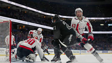 TAMPA, FL - DECEMBER 14: Tampa Bay Lightning center Brayden Point (21) is defended by Washington Capitals right wing Tom Wilson (43) as he takes a shot on Washington Capitals goaltender Ilya Samsonov (30) during the NHL game between the Washington Capitals and Tampa Bay Lightning on December 14, 2019 at Amalie Arena in Tampa, FL. (Photo by Mark LoMoglio/Icon Sportswire via Getty Images)