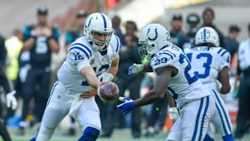 Oct 2, 2016; London, ENG; Indianapolis Colts quarterback Andrew Luck (12) hands off to running back Frank Gore (23) against the Jacksonville Jaguars at Wembley Stadium. Mandatory Credit: Steve Flynn-USA TODAY Sports