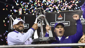 LAS VEGAS, NEVADA - DECEMBER 21: Coaches Jimmy Lake (L) and Chris Petersen of the Washington Huskies celebrate with the game trophy after defeating the Boise State Broncos 38-7 in the Mitsubishi Motors Las Vegas Bowl at Sam Boyd Stadium on December 21, 2019 in Las Vegas, Nevada. (Photo by David Becker/Getty Images)