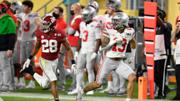 MIAMI GARDENS, FLORIDA - JANUARY 11: Gee Scott Jr. #13 of the Ohio State Buckeyes runs down the field against Josh Jobe #28 of the Alabama Crimson Tide during the College Football Playoff National Championship football game at Hard Rock Stadium on January 11, 2021 in Miami Gardens, Florida. The Alabama Crimson Tide defeated the Ohio State Buckeyes 52-24. (Photo by Alika Jenner/Getty Images)
