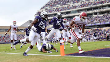 Oct 20, 2018; Fort Worth, TX, USA; Oklahoma Sooners running back Kennedy Brooks (26) runs for a touchdown past TCU Horned Frogs defensive end Ben Banogu (15) during the first half at Amon G. Carter Stadium. Mandatory Credit: Kevin Jairaj-USA TODAY Sports
