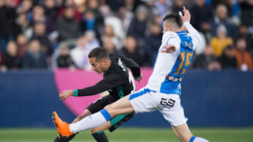 LEGANES, SPAIN - FEBRUARY 21: Lucas Vazquez of Real Madrid shoots past Diego Rico of CD Leganes to score his team's first goal during the La Liga match between Leganes and Real Madrid at Estadio Municipal de Butarque on February 21, 2018 in Leganes, Spain. (Photo by Denis Doyle/Getty Images )