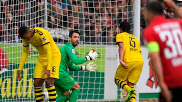 (L-R) Dortmund's Swiss defender Manuel Akanji, Dortmund's Swiss goalkeeper Roman Buerki and Dortmund's German defender Mats Hummels react after an own goal during the German first division Bundesliga football match SC Freiburg vs Borussia Dortmund in Freiburg, southern Germany, on October 5, 2019. (Photo by THOMAS KIENZLE / AFP) / DFL REGULATIONS PROHIBIT ANY USE OF PHOTOGRAPHS AS IMAGE SEQUENCES AND/OR QUASI-VIDEO (Photo by THOMAS KIENZLE/AFP via Getty Images)