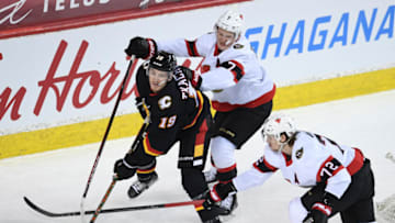 Mar 4, 2021; Calgary, Alberta, CAN; Calgary Flames forward Matthew Tkachuk (19) and Ottawa Senators forward Brady Tkachuk (7) collide in the first period at Scotiabank Saddledome. Mandatory Credit: Candice Ward-USA TODAY Sports