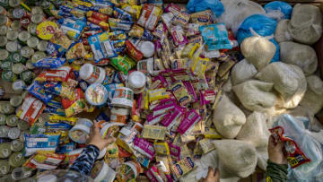 MANILA, PHILIPPINES - APRIL 19: Assorted goods including canned food, noodles, biscuits, rice, and facemasks are seen stocked at the Maginhawa community pantry on April 19, 2021 in Quezon city, Metro Manila, Philippines. Young entrepreneur Ana Patricia Non initiated a community pantry in Maginhawa Street (coincidentally, Maginhawa is the Filipino word for "relief") which operates on the principle of "give what you can and take what you need." The pantry is stocked with basic necessities such as food, toiletries, and medicine donated by kindhearted people and available for free to anyone in need. Within days her idea spread on social media and inspired several other community pantries to sprout all over the country. Many say the pantries have flourished as a result of insufficient government action in addressing the pandemic and the millions of Filipinos going jobless and hungry as a result of strict lockdown measures. The Philippines is currently suffering the worst Covid-19 outbreak in Southeast Asia with more than 936,000 confirmed cases and with the most number of active cases in the region. (Photo by Ezra Acayan/Getty Images)