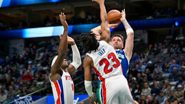 Jan 30, 2023; Dallas, Texas, USA; Dallas Mavericks guard Luka Doncic (77) looks to passes the ball over Detroit Pistons guard Jaden Ivey (23) and center Jalen Duren (0) during the first quarter at the American Airlines Center. Mandatory Credit: Jerome Miron-USA TODAY Sports