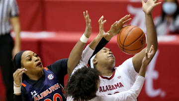 Auburn forward Unique Thompson (20) and Alabama forward Ariyah Copeland (22) fight for a rebound as they play Sunday, Jan. 24, 2021, in Coleman Coliseum. [Staff Photo/Gary Cosby Jr.]Alabama Vs Auburn Women S Sec Basketball