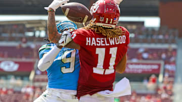 Sep 4, 2021; Norman, Oklahoma, USA; Oklahoma Sooners wide receiver Jadon Haselwood (11) and Tulane Green Wave cornerback Jaylon Monroe (9) battle for the ball during the second quarter at Gaylord Family-Oklahoma Memorial Stadium. Mandatory Credit: Kevin Jairaj-USA TODAY Sports