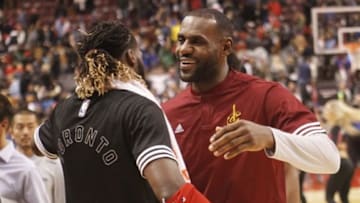 Oct 18, 2015; Toronto, Ontario, CAN; Cleveland Cavaliers forward LeBron James (right) greets Toronto Raptors forward DeMarre Carroll (left) at the end of the game at the Air Canada Centre. Toronto defeated Cleveland 87-81. Mandatory Credit: John E. Sokolowski-USA TODAY Sports