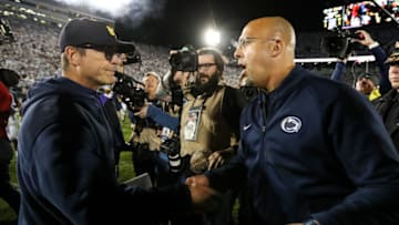 Oct 19, 2019; University Park, PA, USA; Penn State Nittany Lions head coach James Franklin (right) shakes hand with Michigan Wolverines head coach Jim Harbaugh (left) following the completion of the game at Beaver Stadium. Penn State defeated Michigan 28-21. Mandatory Credit: Matthew O'Haren-USA TODAY Sports