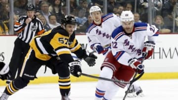 Nov 15, 2014; Pittsburgh, PA, USA; New York Rangers defenseman Dan Boyle (22) carries the puck up ice as Pittsburgh Penguins center Marcel Goc (57) defends during the first period at the CONSOL Energy Center. Mandatory Credit: Charles LeClaire-USA TODAY Sports
