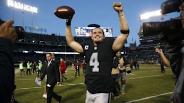 Nov 27, 2016; Oakland, CA, USA; Oakland Raiders quarterback Derek Carr (4) celebrates after the Raiders defeated the Carolina Panthers 35-32 at Oakland Coliseum. Mandatory Credit: Cary Edmondson-USA TODAY Sports