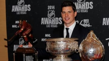 Jun 24, 2014; Las Vegas, NV, USA; Pittsburg Penguins captain Sidney Crosby poses with Ted Lindsay Award, the Art Ross Trophy, and the Hart Trophy after winning all three titles during the 2014 NHL Awards ceremony at Wynn Las Vegas. Mandatory Credit: Stephen R. Sylvanie-USA TODAY Sports
