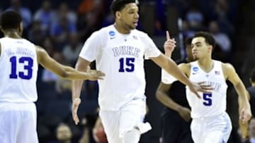 Mar 22, 2015; Charlotte, NC, USA; Duke Blue Devils center Jahlil Okafor (15) celebrates with guard Matt Jones (13) and guard Tyus Jones (5) during the second half against the San Diego State Aztecs in the third round of the 2015 NCAA Tournament at Time Warner Cable Arena. Mandatory Credit: Bob Donnan-USA TODAY Sports