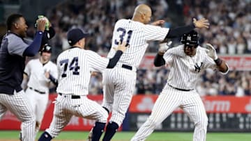 NEW YORK, NY - MAY 04: Miguel Andujar #41 of the New York Yankees is chased by teammates Aaron Hicks #31 and Ronald Torreyes #74 of the New York Yankees after he drove in the game winning run in the bottom of the ninth inning against the Cleveland Indians at Yankee Stadium on May 4, 2018 in the Bronx borough of New York City.The New York Yankees defeated the Cleveland Indians 7-6. (Photo by Elsa/Getty Images)