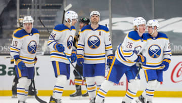 BOSTON, MA - APRIL 13: Rasmus Dahlin #26 of the Buffalo Sabres celebrates with teammates after scoring a goal in the third period against the Boston Bruins at TD Garden on April 13, 2021 in Boston, Massachusetts. (Photo by Adam Glanzman/Getty Images)