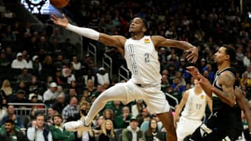 Shai Gilgeous-Alexander #2 of the Oklahoma City Thunder attempts to save the ball during the second half of the game against the Milwaukee Bucks at Fiserv Forum on November 19, 2021 in Milwaukee, Wisconsin. Bucks defeated the Thunder 96-89. NOTE TO USER: User expressly acknowledges and agrees that, by downloading and or using this photograph, User is consenting to the terms and conditions of the Getty Images License Agreement. (Photo by John Fisher/Getty Images)