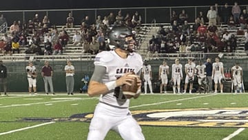 Benedictine's Luke Kromenhoek looks downfield before connecting with La'Don Bryant on a 42-yard Hail Mary touchdown pass to end the first half in a win over New Hampstead Thursday night.Kromenhoek