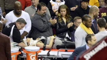 Dec 17, 2015; Cleveland, OH, USA; Ellie Day, wife of golfer Jason Day (not pictured), leaves the arena on a stretcher after she was run into by Cleveland Cavaliers forward LeBron James (not pictured) while she sat in the front row during a game between the Cleveland Cavaliers and the Oklahoma City Thunder at Quicken Loans Arena. Mandatory Credit: David Richard-USA TODAY Sports