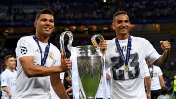 MILAN, ITALY - MAY 28: Casemiro (L) and Danilo of Real Madrid pose with the trophy after winning the UEFA Champions League Final match between Real Madrid and Club Atletico de Madrid at Stadio Giuseppe Meazza on May 28, 2016 in Milan, Italy. (Photo by Matthias Hangst/Getty Images)