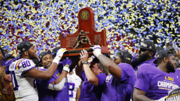 ATLANTA, GEORGIA - DECEMBER 07: The LSU Tigers celebrate with the trophy after defeating the Georgia Bulldogs 37-10 to win the SEC Championship game at Mercedes-Benz Stadium on December 07, 2019 in Atlanta, Georgia. (Photo by Todd Kirkland/Getty Images)