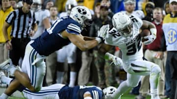 KANSAS CITY, MO - NOVEMBER 14: Running back Russell Hansbrough #32 of the Missouri Tigers picks up a first down against Harvey Langi #21 and Jherremya Leuta-Douyere #43 of the Brigham Young Cougars in the first quarter at Arrowhead Stadium on November 14, 2015 in Kansas City, Missouri. (Photo by Ed Zurga/Getty Images)