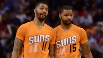 Mar 27, 2015; Phoenix, AZ, USA; Phoenix Suns forward Markieff Morris (11) and Phoenix Suns forward Marcus Morris (15) talk during a timeout against the Portland Trail Blazers at US Airways Center. The Trail Blazers won the game 87-81. Mandatory Credit: Joe Camporeale-USA TODAY Sports