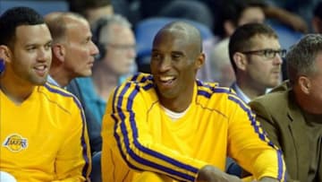 Oct 8, 2013; Ontario, CA, USA; Los Angeles Lakers guard Kobe Bryant (center) and Jordan Farmar react during the game against the Denver Nuggets at Citizens Business Bank Arena. Mandatory Credit: Kirby Lee-USA TODAY Sports