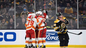 Nov 21, 2021; Boston, Massachusetts, USA; Calgary Flames center Dillon Dube (29) and defenseman Noah Hanifin (55) celebrate a goal with their line mates during the third period against the Boston Bruins at TD Garden. Mandatory Credit: Bob DeChiara-USA TODAY Sports