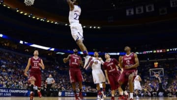 Mar 21, 2014; St. Louis, MO, USA; Kansas Jayhawks guard Andrew Wiggins (22) dunks the ball ahead of Eastern Kentucky Colonels guard Isaac McGlone (5), Glenn Cosey (0) and Marcus Lewis (12) in the first half during the 2nd round of the 2014 NCAA Men