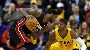 Dec 10, 2013; Indianapolis, IN, USA; Miami Heat guard LeBron James (6) is guarded by Indiana Pacers forward Paul George (24) at Bankers Life Fieldhouse. Indiana defeats Miami 90-84. Mandatory Credit: Brian Spurlock-USA TODAY Sports