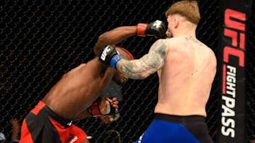 LONDON, ENGLAND - MARCH 18: (L-R) Marc Diakiese of the Congo punches Teemu Packalen of Finland in their lightweight fight during the UFC Fight Night event at The O2 arena on March 18, 2017 in London, England. (Photo by Josh Hedges/Zuffa LLC/Zuffa LLC via Getty Images)