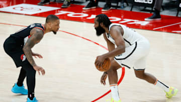 PORTLAND, OREGON - MARCH 23: Damian Lillard #0 of the Portland Trail Blazers defends against James Harden #13 of the Brooklyn Nets during the fourth quarter at Moda Center on March 23, 2021 in Portland, Oregon. NOTE TO USER: User expressly acknowledges and agrees that, by downloading and or using this photograph, User is consenting to the terms and conditions of the Getty Images License Agreement. (Photo by Steph Chambers/Getty Images)