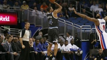 Feb 5, 2014; Orlando, FL, USA; Orlando Magic shooting guard Arron Afflalo (4) shoots a three pointer over Detroit Pistons center Andre Drummond (0) during the first quarter at Amway Center. Mandatory Credit: Kim Klement-USA TODAY Sports