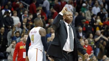 Jan 27, 2016; Atlanta, GA, USA; Los Angeles Clippers head coach Doc Rivers celebrates their win as Atlanta Hawks forward Paul Millsap (4) walks off of the court just as time expires in their game at Philips Arena. The Clippers won 85-83. Mandatory Credit: Jason Getz-USA TODAY Sports