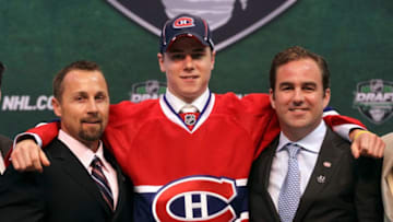 ST PAUL, MN - JUNE 24: Seventh overall pick Nathan Beaulieu by the Montreal Canadiens stands onstage for a photo with Director of Procurement and Player Development Trevor Timmins and a member of the Montreal Canadiens organization during day one of the 2011 NHL Entry Draft at Xcel Energy Center on June 24, 2011 in St Paul, Minnesota. (Photo by Bruce Bennett/Getty Images)