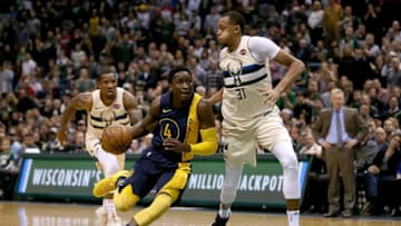 MILWAUKEE, WI - MARCH 02: Victor Oladipo #4 of the Indiana Pacers dribbles the ball while being guarded by John Henson #31 of the Milwaukee Bucks in the fourth quarter at the Bradley Center on March 2, 2018 in Milwaukee, Wisconsin. NOTE TO USER: User expressly acknowledges and agrees that, by downloading and or using this photograph, User is consenting to the terms and conditions of the Getty Images License Agreement. (Photo by Dylan Buell/Getty Images)