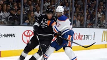 Oct 14, 2014; Los Angeles, CA, USA; Los Angeles Kings center Jordan Nolan (71) and Edmonton Oilers defenseman Darnell Nurse (25) battle for the puck in the first period at the Staples Center. Mandatory Credit: Kirby Lee-USA TODAY Sports