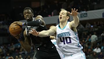CHARLOTTE, NC - DECEMBER 12: Reggie Jackson #1 of the Detroit Pistons collides with Cody Zeller #40 of the Charlotte Hornets during their game at Spectrum Center on December 12, 2018 in Charlotte, North Carolina. NOTE TO USER: User expressly acknowledges and agrees that, by downloading and or using this photograph, User is consenting to the terms and conditions of the Getty Images License Agreement. (Photo by Streeter Lecka/Getty Images)