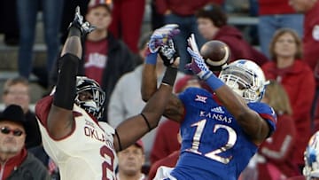 Oct 31, 2015; Lawrence, KS, USA; Kansas Jayhawks wide receiver Darious Crawley (12) is unable to catch this pass while defended by Oklahoma Sooners cornerback P.J. Mbanasor (2) in the second half at Memorial Stadium. Oklahoma won the game 62-7. Mandatory Credit: John Rieger-USA TODAY Sports