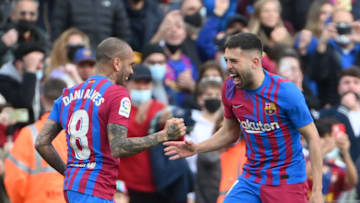 Barcelona's Spanish defender Jordi Alba (R) celebrates with Barcelona's Brazilian defender Dani Alves. (Photo by LLUIS GENE/AFP via Getty Images)