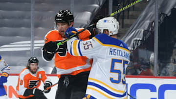 PHILADELPHIA, PA - JANUARY 19: James van Riemsdyk #25 of the Philadelphia Flyers is checked by Rasmus Ristolainen #55 of the Buffalo Sabres in the first period at Wells Fargo Center on January 19, 2021 in Philadelphia, Pennsylvania. (Photo by Drew Hallowell/Getty Images)