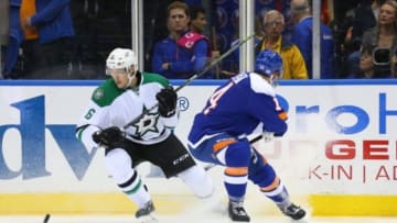 Oct 25, 2014; Uniondale, NY, USA; New York Islanders defenseman Thomas Hickey (14) sends a pass behind Dallas Stars left wing Ryan Garbutt (16) during the first period at Nassau Veterans Memorial Coliseum. Mandatory Credit: Anthony Gruppuso-USA TODAY Sports