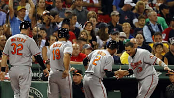 Sep 13, 2016; Boston, MA, USA; As Baltimore Orioles manager Buck Showalter (26) (center) looks on as shortstop J.J. Hardy (2) is congratulated by third baseman Manny Machado (13) as catcher Matt Wieters (32) and first baseman Chris Davis (19) looks on after his three-run home run against the Boston Red Sox during the second inning at Fenway Park. Mandatory Credit: Winslow Townson-USA TODAY Sports