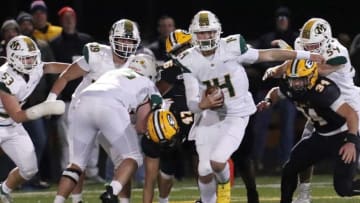 Medina quarterback Drew Allar evades Lakewood St. Edward defenders in Div. I regional football final at Byers Field at Robert Boulton Stadium in Parma. Medina lost to St. Edward 41 to 6.Medinafb 11 21 12
